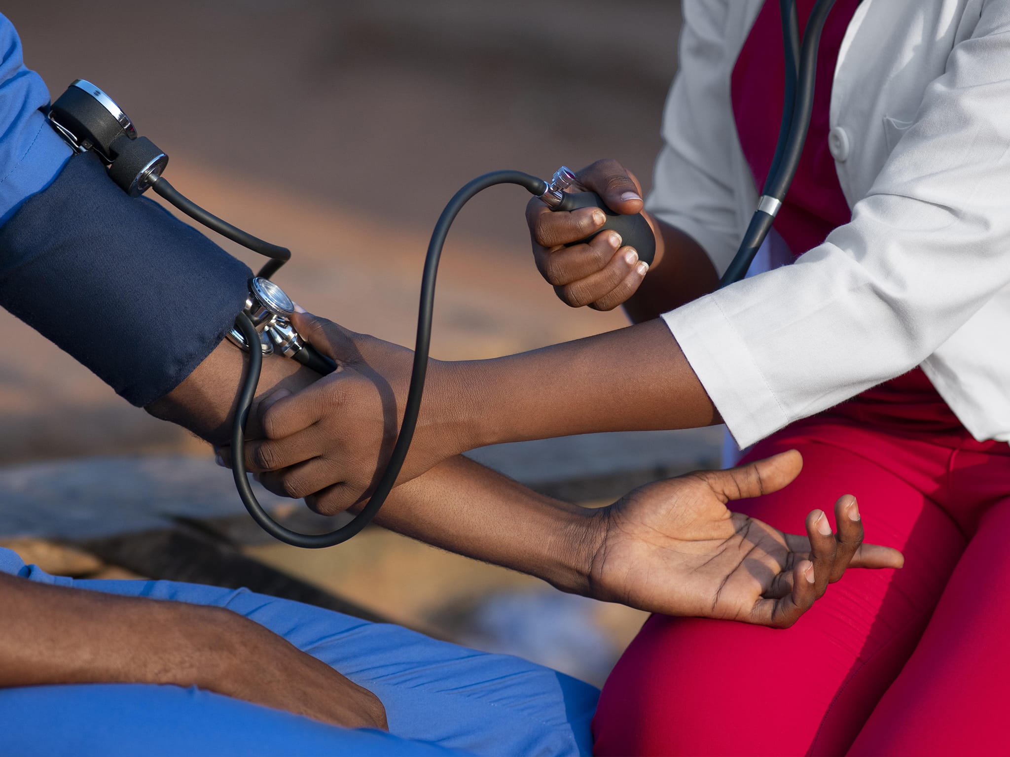 Un soignant de la Résidence La Cordyline mesurant la tension artérielle d’un résident, illustrant l’attention médicale personnalisée